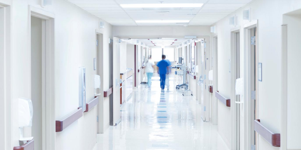 Doctors walking down a hospital corridor.