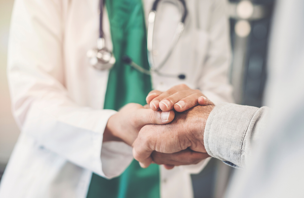 Photo of doctor holding patient's hand