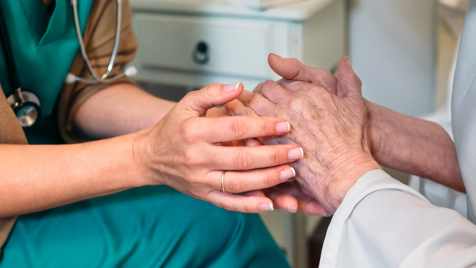 A healthcare provider and patient in a hospice setting.