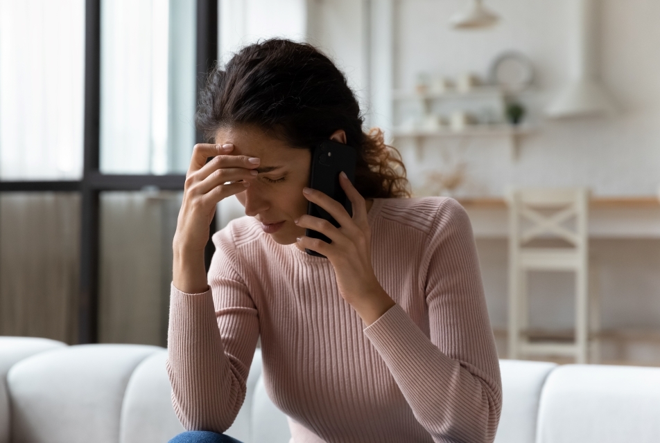 Photo of woman on phone looking stressed