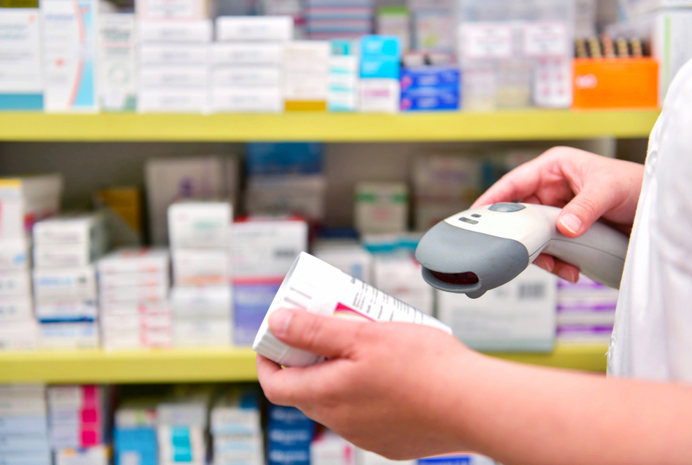 Image of pharmacist scanning drug