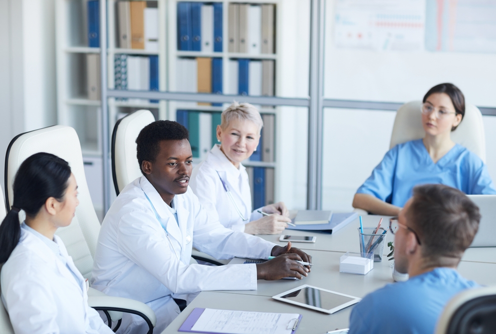 Photo of physicians sitting at table
