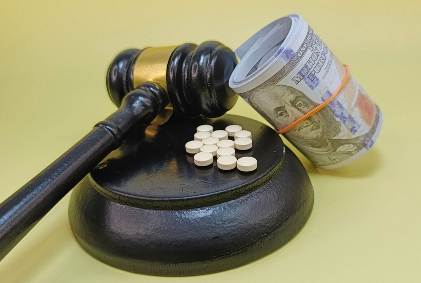 Image of gavel with pills and money