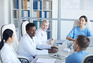 Photo of physicians sitting at table