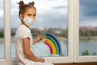 Photo of girl painting at window